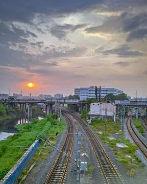 Beautiful sunset with monsoon clouds over three rail routes in Chennai, India Stock-Fotos