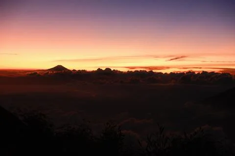 A beautiful sunset with a mountain in the background Stock Photos