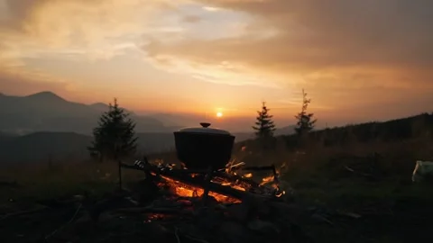 Beautiful sunset in the mountains. Against the background of the sunset, a Stock Footage 272268872