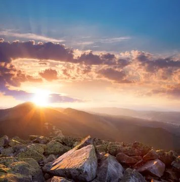 Beautiful sunset in the mountains landscape. dramatic sky and colorful stones Stock Photos