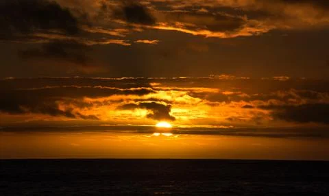 Beautiful sunset on the ocean with cloudy dramatic sky background 스톡 사진