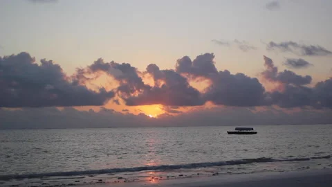 Beautiful sunset over beach with clouds and boat Stock Footage 143345589