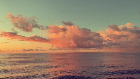Beautiful sunset over calm ocean with colorful clouds reflecting on the wat.. Stock Footage 338281845