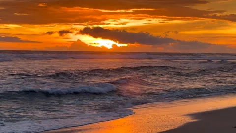 Beautiful sunset over the coastline of Watu Kodok Beach in Gunung Kidul Stock Footage 338015053