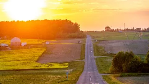 Beautiful sunset over an empty road in the countryside. An empty asphalt ro.. Stock Photos