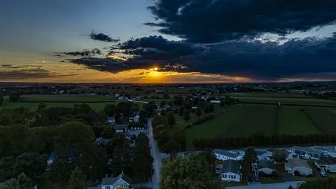 Beautiful Sunset Over Fields and Small Town During Evening Hours in Rural Are Stock Photos