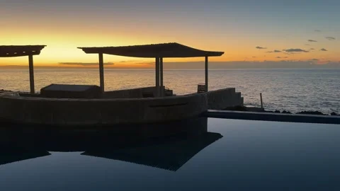 Beautiful sunset over glassy pool and ocean Stock Footage 330879096