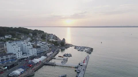 A beautiful sunset over a harbor with a few boats docked Stock Footage 297950068