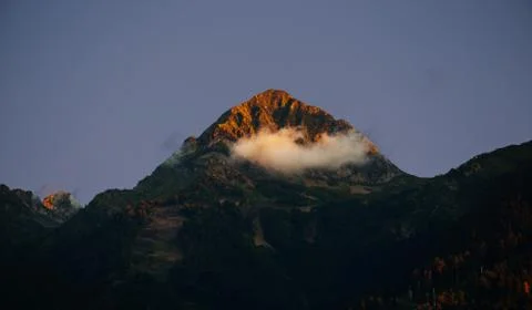 Beautiful sunset over mountain peak. North Caucasus. Stock Photos