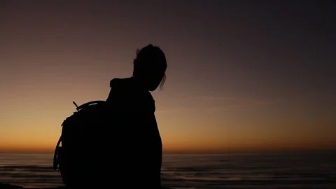 Beautiful sunset over ocean and person's silhouette Stock Footage 123143467