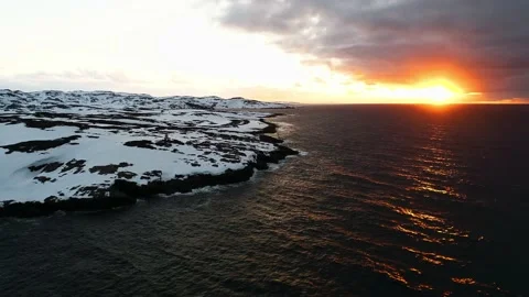 A beautiful sunset over the ocean, the sun is covered by storm clouds. The drone Stock Footage 169464265