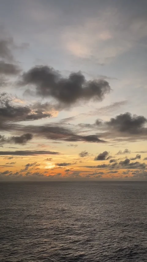 Beautiful sunset over ocean waves with colorful clouds in the evening sky Stock Footage 307883978