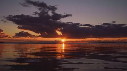 Beautiful sunset over reflective calm sea Stock Footage 168773628