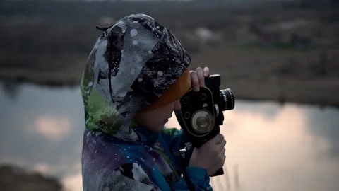 Beautiful sunset over the river. the boy takes the evening landscape Stock Footage 128330190