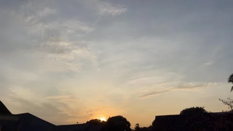 Beautiful Sunset Over Rooftops With a Vibrant Sky Stock Footage 310823737