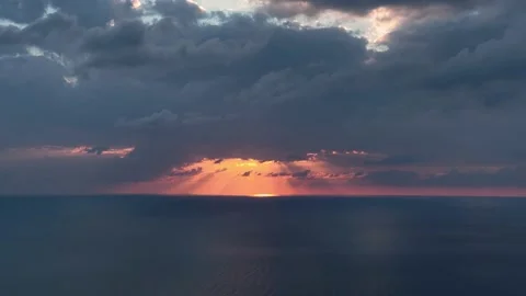 Beautiful sunset over sea with cloudy orange sky. Sun touches sea horizon Stock Footage 225075752