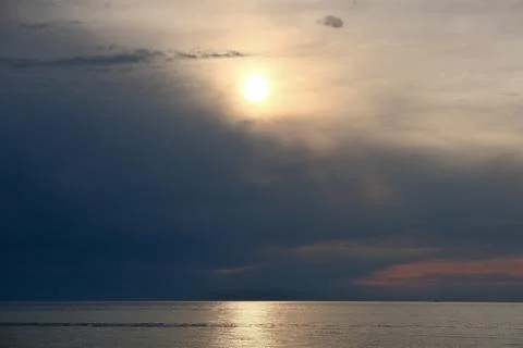 Beautiful Sunset Over the Sea with Dramatic Clouds and Sun Glitter on Water Stock Photos