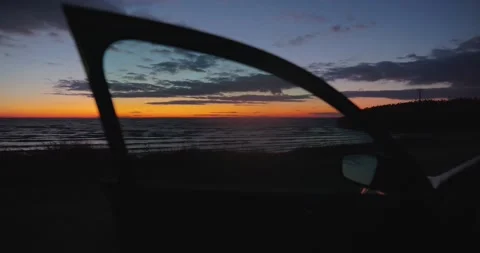 Beautiful sunset over the sea through car door, contains original audio 스톡 동영상 319442175