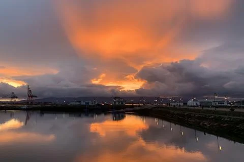 Beautiful sunset over seaport dramatic landscape Stock Photos