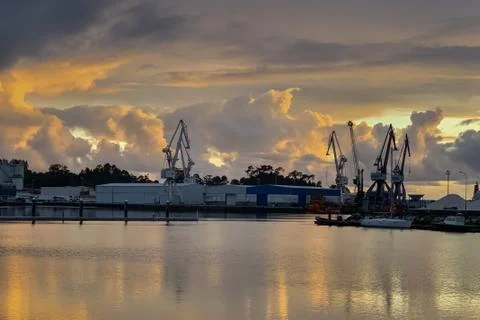 Beautiful sunset over seaport dramatic landscape Stock Photos