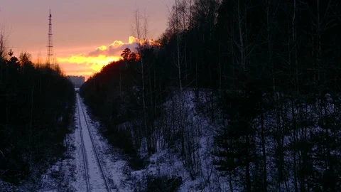 Beautiful Sunset over a Snowy Train Track Stock-Footage 76389322