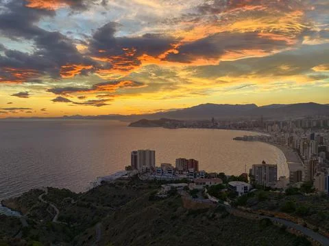 Beautiful sunset over tranquil bay showcasing luxury accommodations and Stock Photos