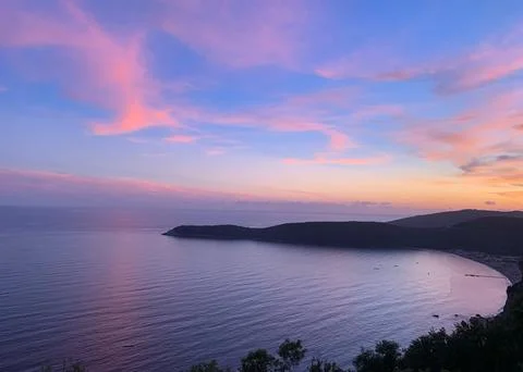 Beautiful Sunset Over Tranquil River Surrounded by Forests and Hills Stock Photos