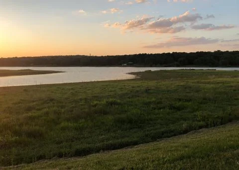Beautiful Sunset Over Tranquil River Surrounded by Forests and Hills Stock Photos