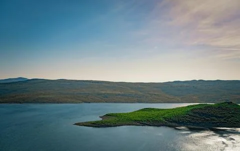 Beautiful Sunset Over Tranquil River Surrounded by Forests and Hills Stock Photos