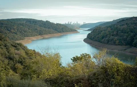 Beautiful Sunset Over Tranquil River Surrounded by Forests and Hills Stock Photos