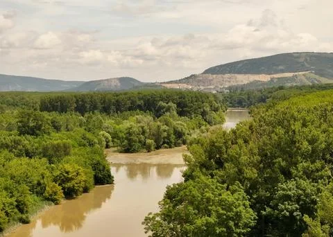 Beautiful Sunset Over Tranquil River Surrounded by Forests and Hills Stock Photos