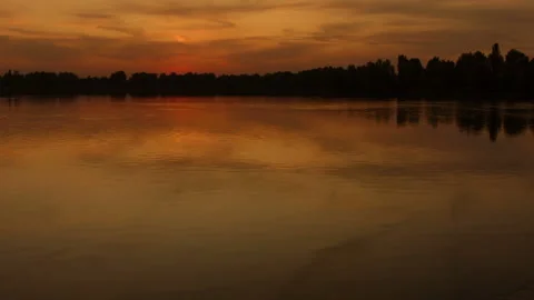 Beautiful sunset over the water surface of the river. Recorded in Raw on Blackma Stock Footage 122049515