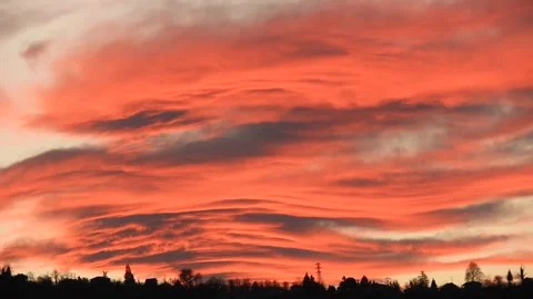 Beautiful sunset paints the sky with dense red clouds and glowing crimson layers Stock Footage 339586651