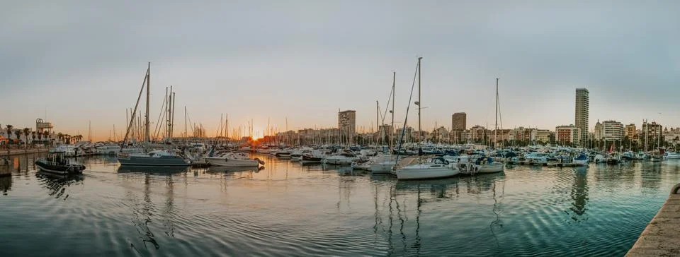 Beautiful sunset at port of Alicante, Spain at Mediterranean sea Stock Photos