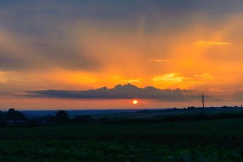 Beautiful sunset with rays of the sun to clouds. Stock Photos