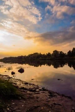 Beautiful sunset reflected in clouds and water Stock Photos