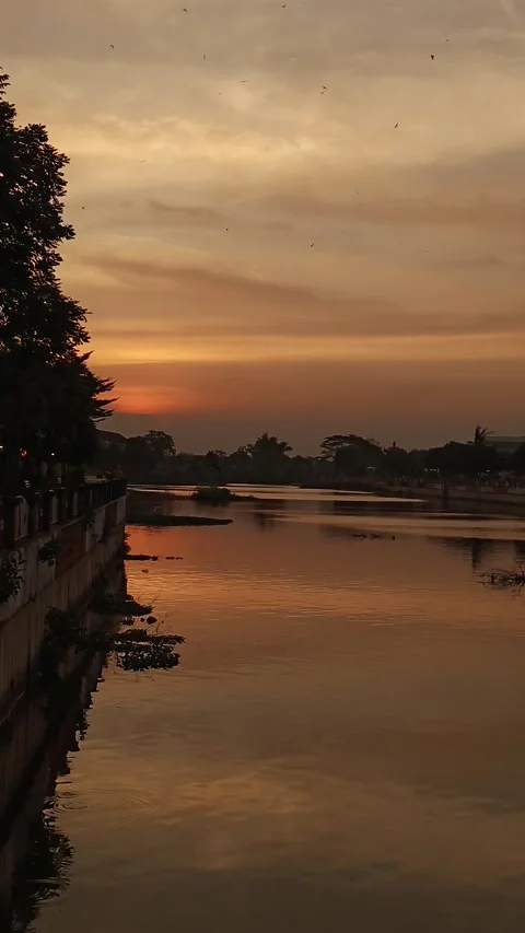 Beautiful sunset reflecting on calm river waters. Stock Footage 313286181