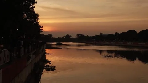 Beautiful sunset reflecting on calm river waters. Stock Footage 313286205