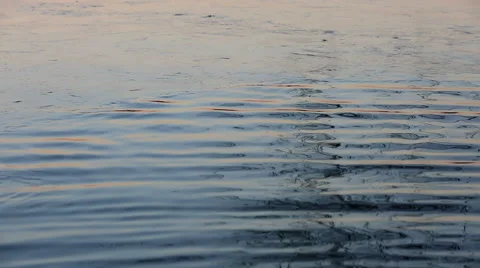 Beautiful sunset reflections on lake surface with thin ice, waves with sun Stock Footage 58650767