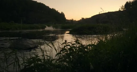 Beautiful sunset reflects on the river Stock Footage 132893623