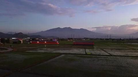 Beautiful sunset in rice fields with drone moving forward Stock Footage 284299082