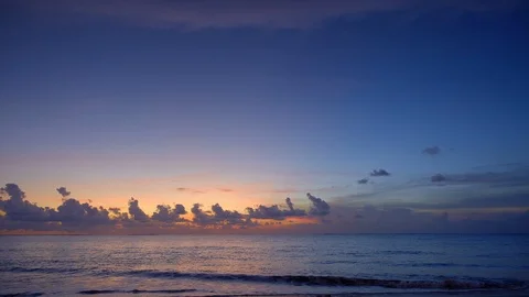 Beautiful sunset on sandy beach with dark blue sky and dramatic clouds Video stock 113269333