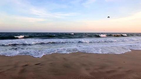 Beautiful sunset on sandy beach water and waves sea landscape with kites Stock Footage 126818509