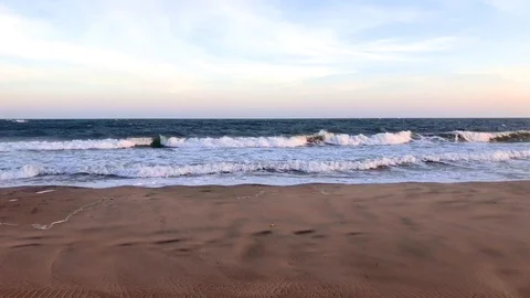 Beautiful sunset on sandy beach water and waves sea landscape Stock Footage 126818512