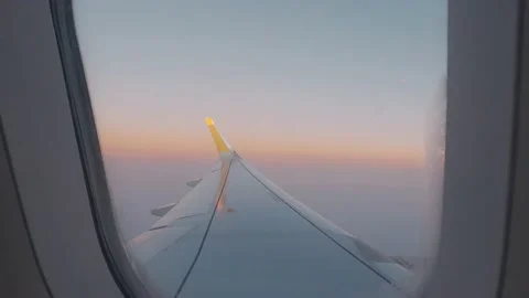 Beautiful sunset scenic view of clouds and sky seen through aircraft window with Stock Footage 171894704