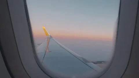 Beautiful sunset scenic view of clouds and sky seen through aircraft window with 库存影片 171902201
