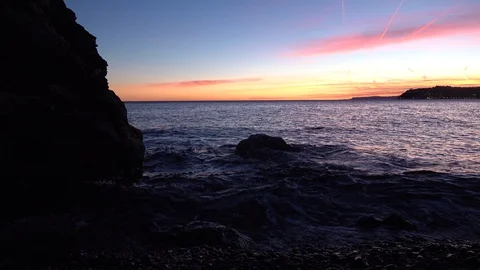 BEAUTIFUL SUNSET IN THE SEA WITH THE CLOUDS THAT BECOME RED Stock Footage 100975790