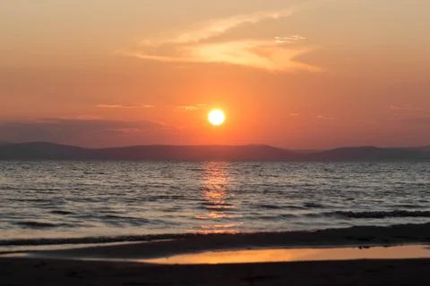 Beautiful sunset on the sea. Reflection of the sunset in the water Fotos Stock