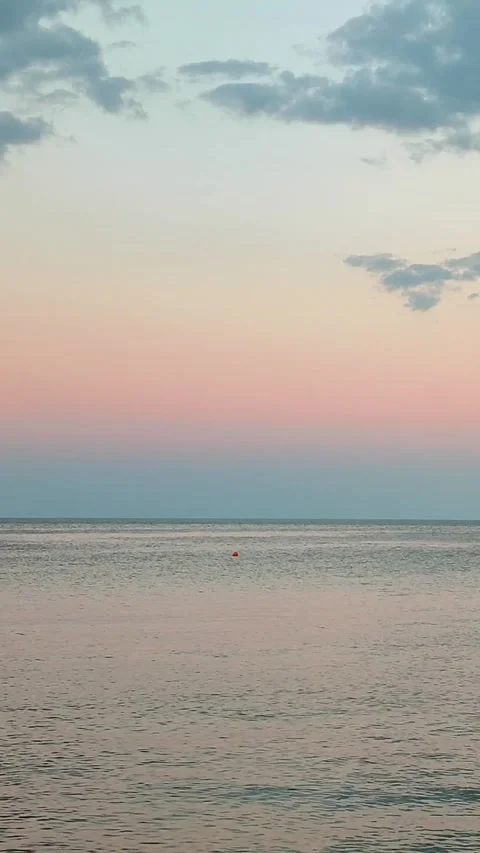 Beautiful sunset sea Surface of calm blue sea blue sky with clouds horizon line Stock Footage 307207702