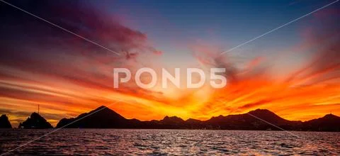 Beautiful Sunset of Seascape with Mountains silhouets. Sea off the Coast of C Stock Photos